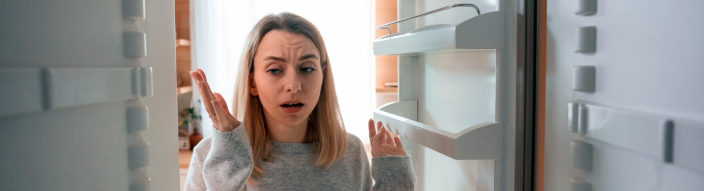woman upset over faulty light in fridge
